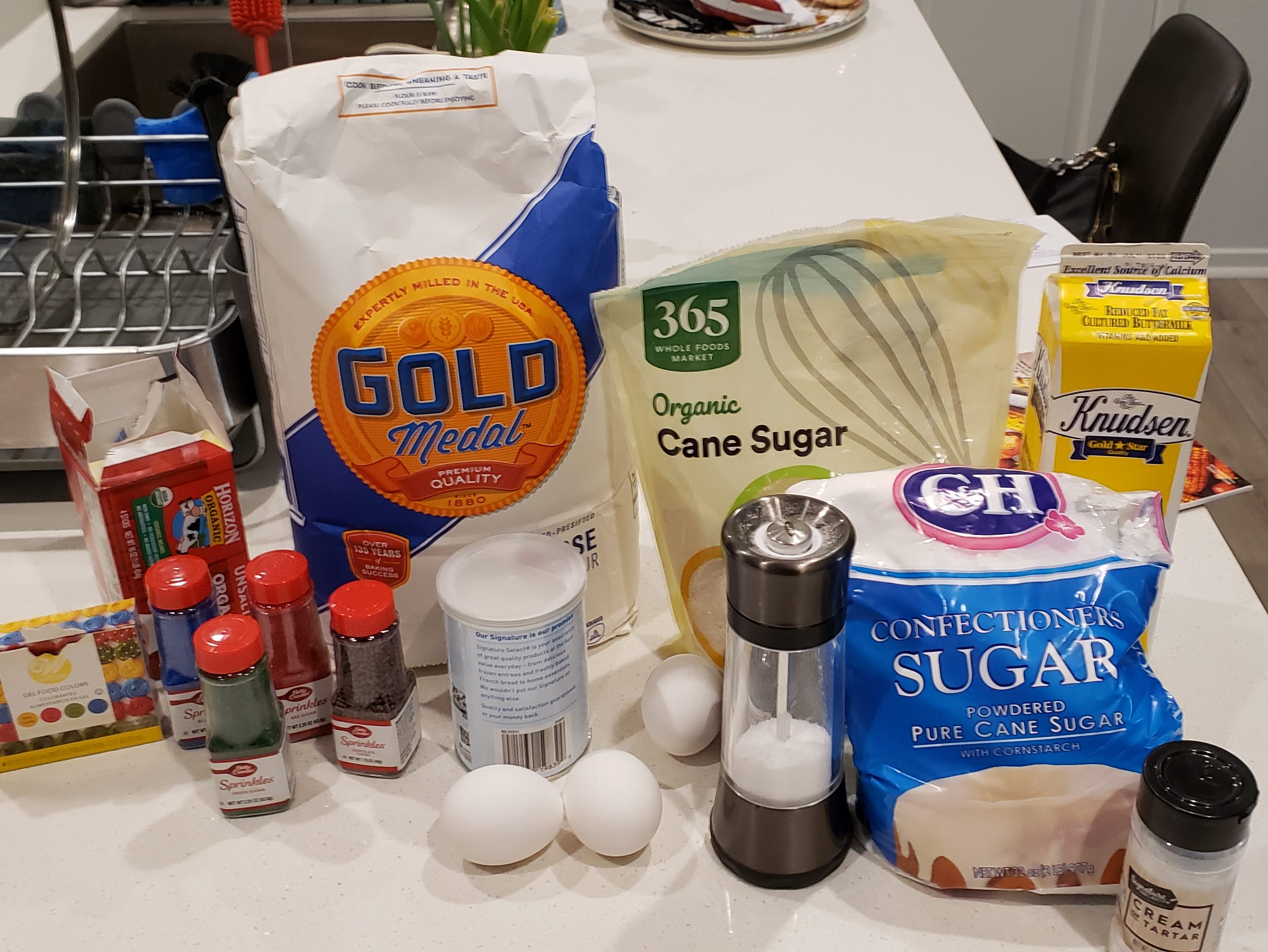 The ingredients for making Grandma Manly's Christmas cookies: (From left to right) Food coloring, butter, sprinkles, flour, baking powder, eggs, salt, sugar, powdered sugar, buttermilk and cream of tartar.